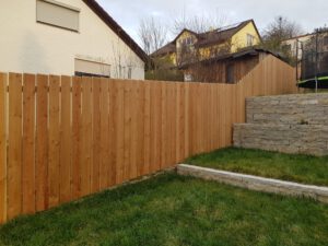 Sichtschutzwand aus Holz. Bretter senkrecht angeordnet.